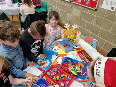 Children enjoying crafts at a community activity