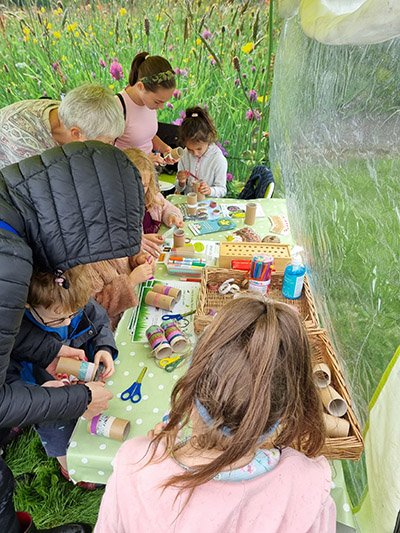 Families taking part in crafts at an outdoor community event